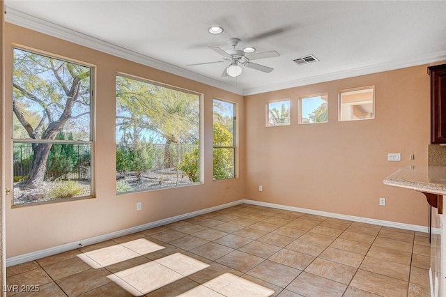 unfurnished dining area with ceiling fan, light tile patterned flooring, and ornamental molding