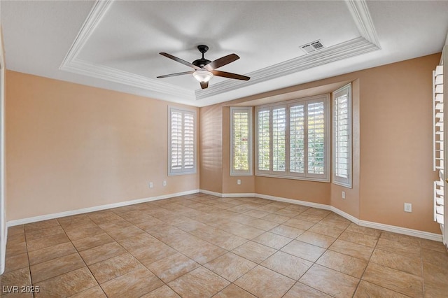 tiled spare room featuring a tray ceiling, ceiling fan, and ornamental molding