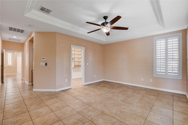 tiled spare room with a tray ceiling, plenty of natural light, ceiling fan, and crown molding