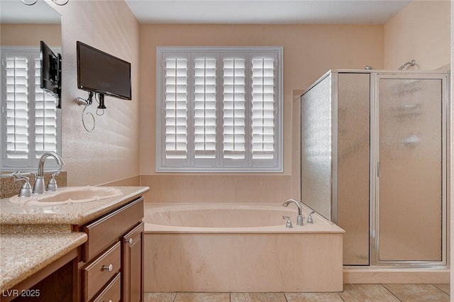 bathroom featuring tile patterned flooring, vanity, and plus walk in shower