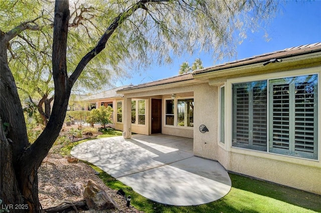 back of house with a patio