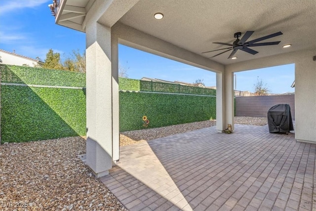 view of patio with ceiling fan and a grill