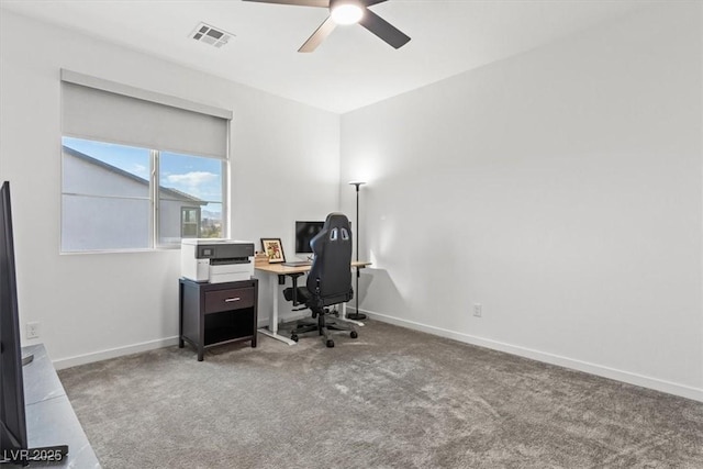 carpeted office space with ceiling fan