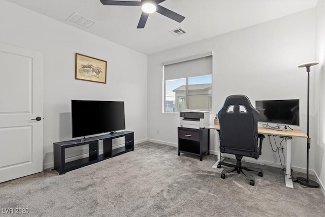 home office with ceiling fan and carpet