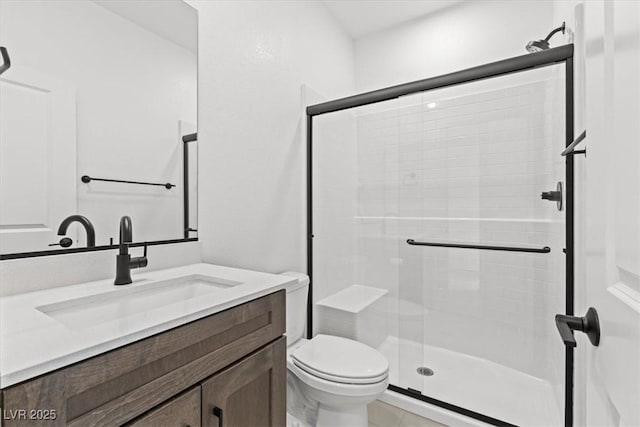 bathroom featuring vanity, toilet, and walk in shower