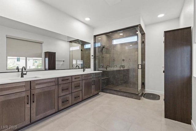 bathroom featuring vanity, tile patterned floors, and walk in shower