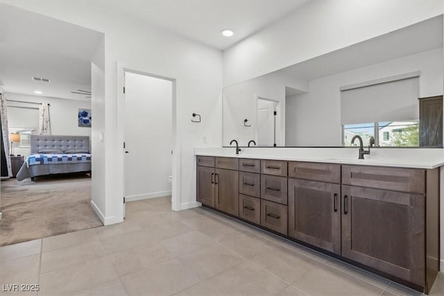 bathroom featuring tile patterned floors, vanity, and toilet