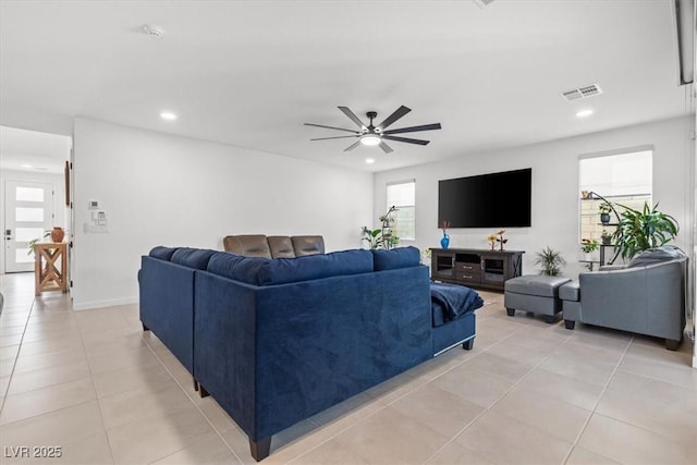 living room with ceiling fan and light tile patterned flooring