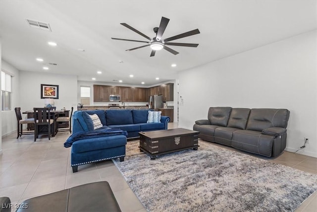 tiled living room with ceiling fan