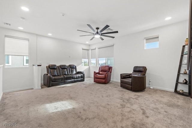 carpeted living room featuring ceiling fan