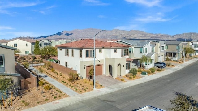 mediterranean / spanish-style home featuring a mountain view and a garage