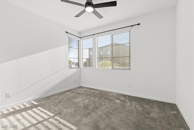 spare room with ceiling fan and carpet