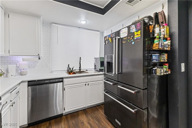 kitchen with dark wood-style floors, visible vents, white cabinetry, dishwasher, and black refrigerator with ice dispenser