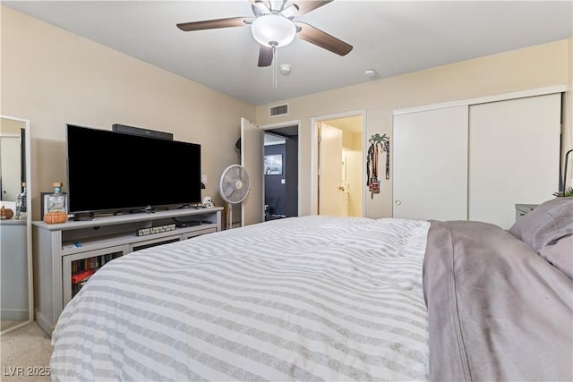 bedroom with light colored carpet, a closet, visible vents, and ceiling fan