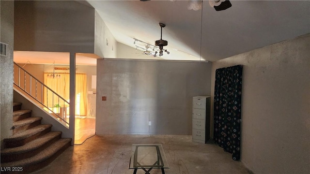 interior space featuring vaulted ceiling and concrete floors