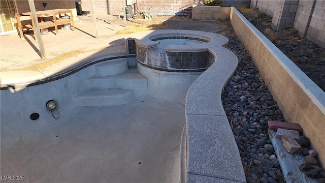 view of pool featuring a patio area and an in ground hot tub