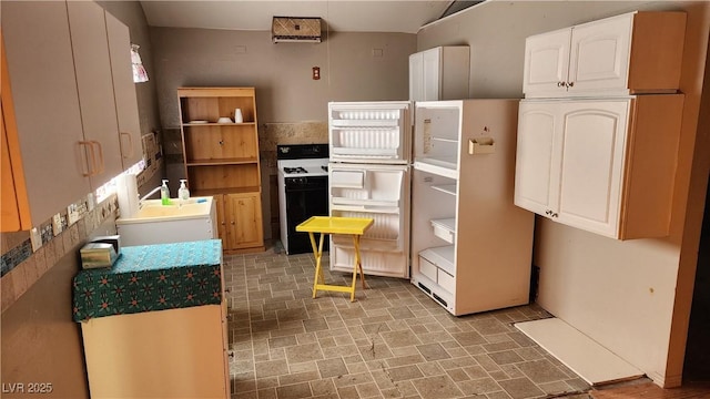 kitchen featuring gas stove and white cabinets