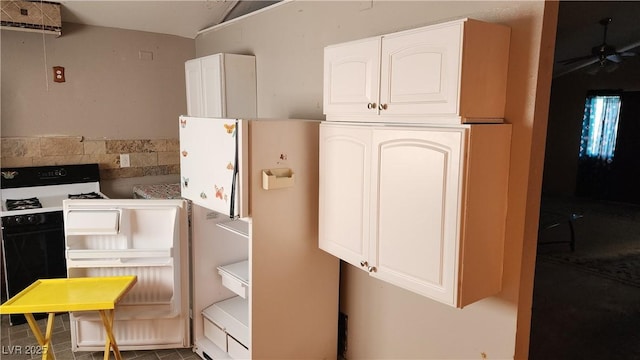 kitchen featuring white cabinetry, ceiling fan, and white fridge