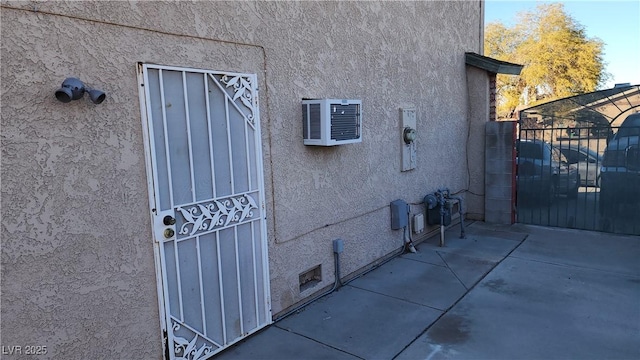 view of side of home with a wall mounted AC