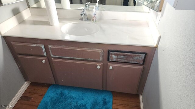 bathroom featuring hardwood / wood-style flooring and vanity