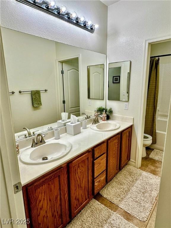 full bathroom with vanity, shower / bath combo, and toilet