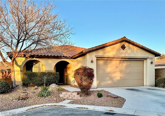 mediterranean / spanish-style home featuring a garage