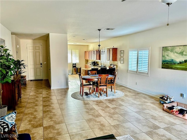 dining space with light tile patterned floors and sink