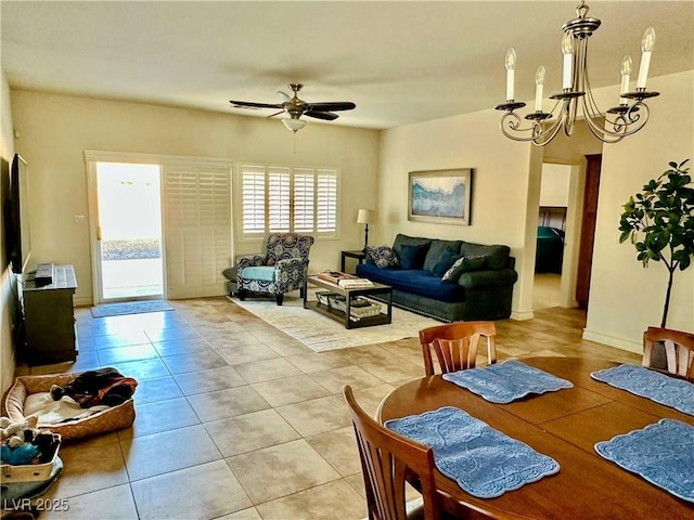 dining space with light tile patterned flooring and ceiling fan with notable chandelier