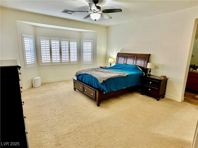 bedroom with ceiling fan and light colored carpet