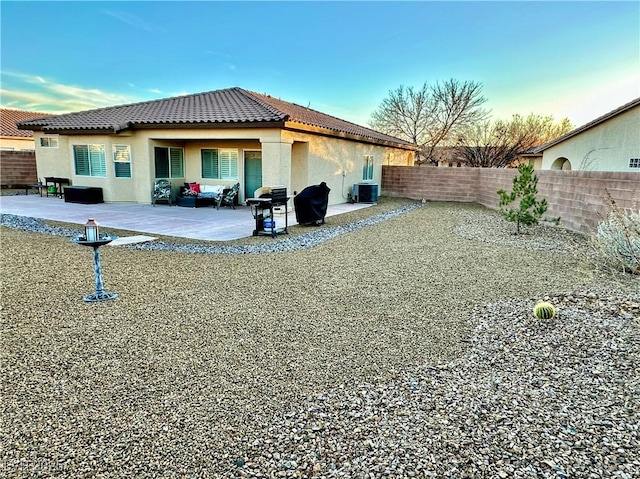 rear view of property with cooling unit and a patio area