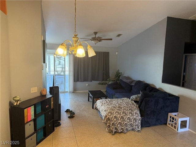 living area with a ceiling fan, visible vents, and light tile patterned floors