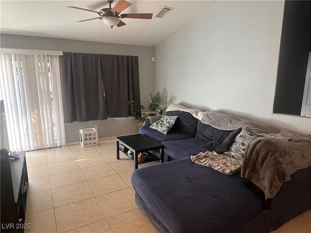 living area with lofted ceiling, ceiling fan, visible vents, and light tile patterned flooring