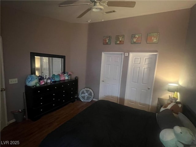 bedroom with wood finished floors, visible vents, and a ceiling fan