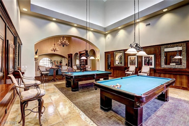 rec room with a towering ceiling and pool table