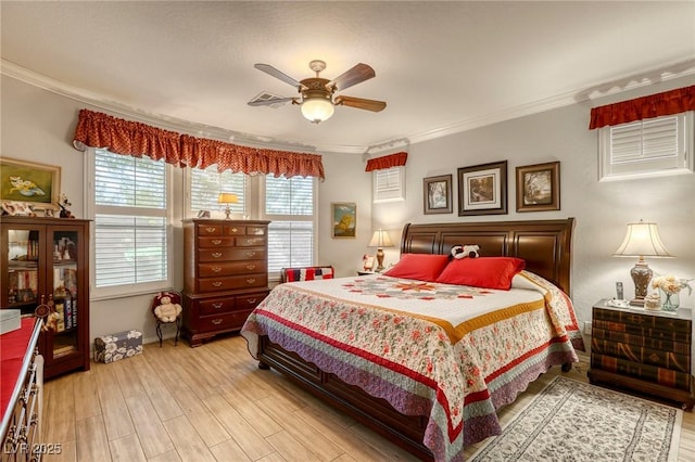 bedroom with light hardwood / wood-style flooring, ceiling fan, and ornamental molding