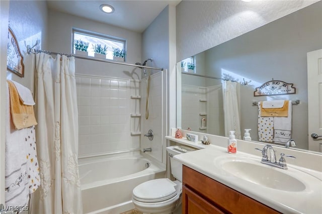 full bathroom featuring vanity, shower / bathtub combination with curtain, and toilet