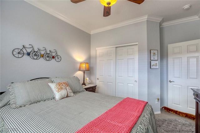 bedroom with ceiling fan, crown molding, and a closet