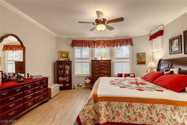 bedroom with ceiling fan, light wood-type flooring, and crown molding