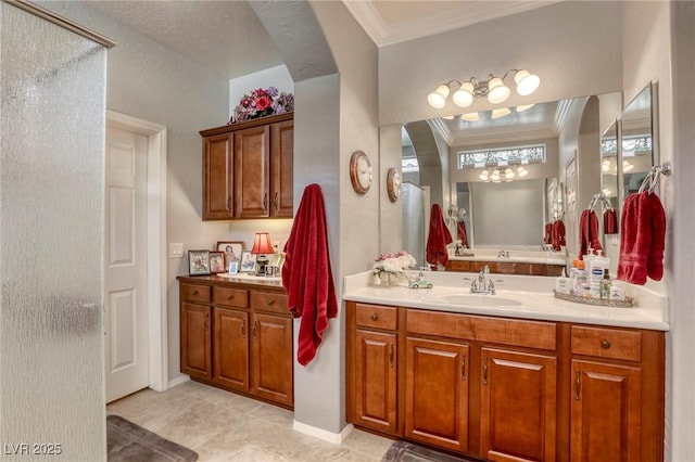 bathroom featuring tile patterned floors, vanity, a shower with door, and ornamental molding