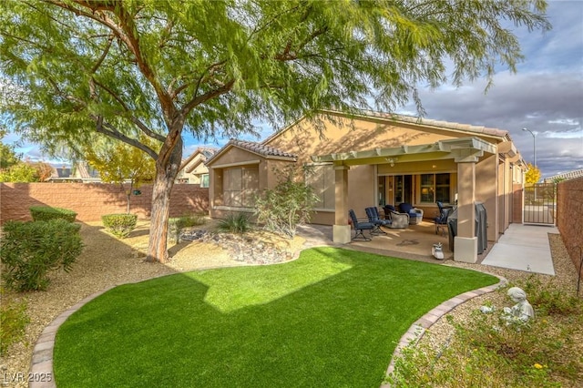 rear view of property with a patio area and a yard