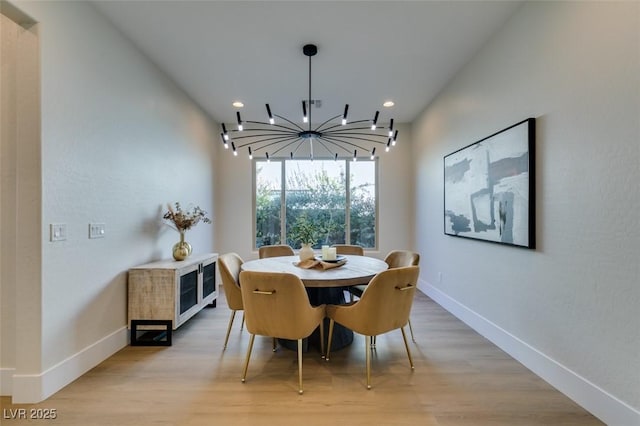 dining space featuring a chandelier and light hardwood / wood-style floors