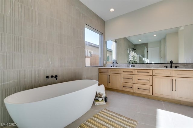 bathroom featuring tile patterned floors, vanity, separate shower and tub, and tile walls