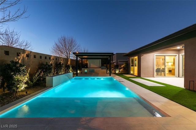 pool at dusk with a patio area