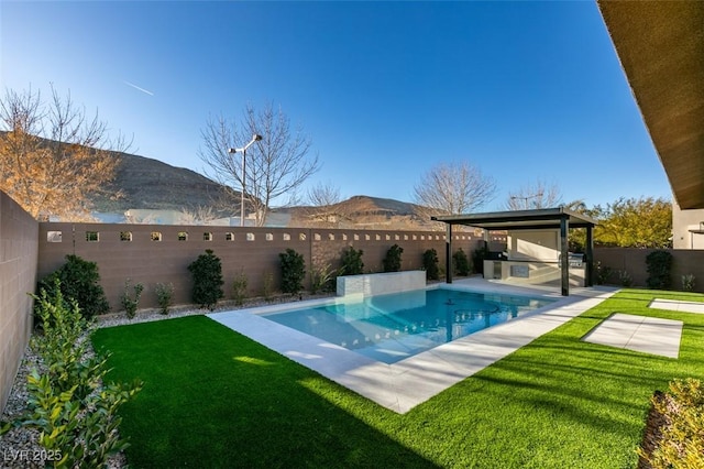 view of swimming pool featuring a mountain view, area for grilling, and a yard