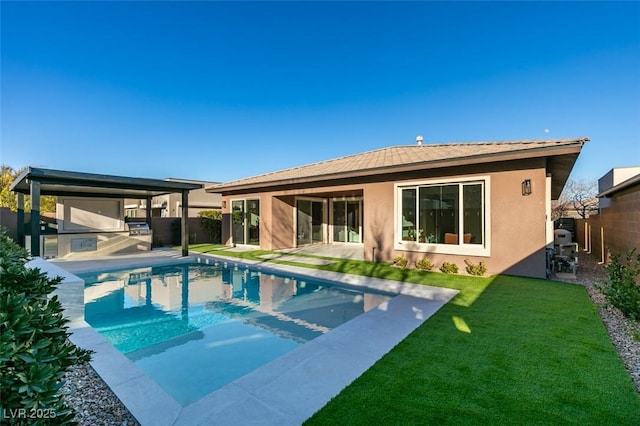 back of house featuring a lawn, a fenced in pool, and a patio