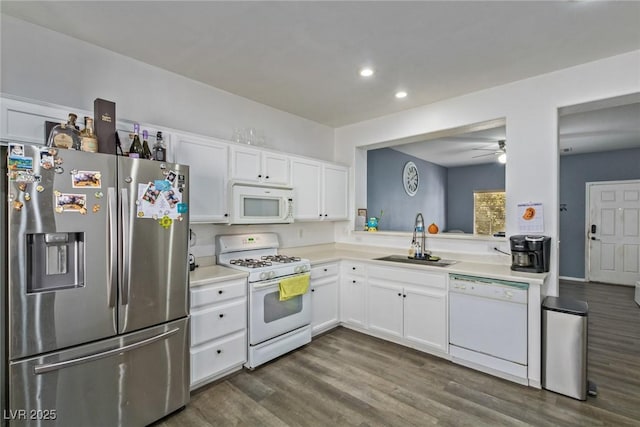 kitchen with white appliances, ceiling fan, sink, white cabinets, and dark hardwood / wood-style floors