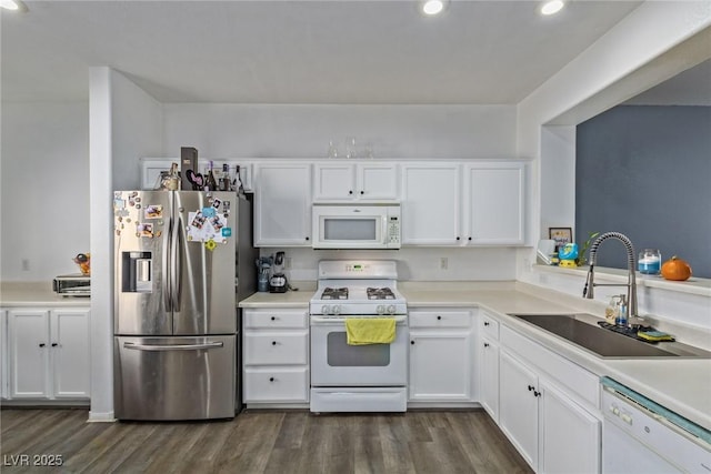 kitchen with dark hardwood / wood-style floors, white cabinetry, white appliances, and sink