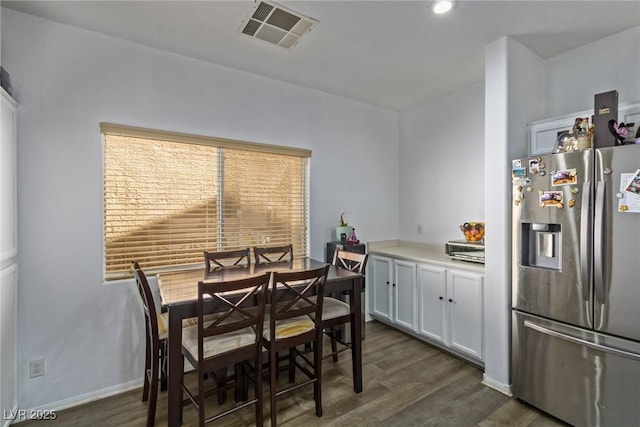 dining area featuring dark wood-type flooring