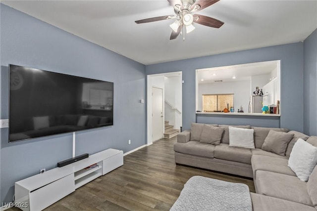 living room featuring dark hardwood / wood-style floors and ceiling fan