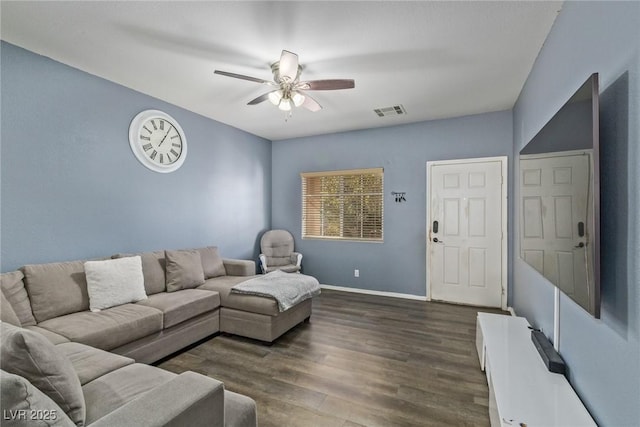 living room featuring dark hardwood / wood-style flooring and ceiling fan